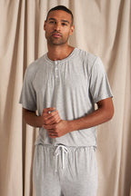 Men's bamboo pajama short set in grey matching shorts with drawstring and side pockets. Top is a t-shirt style with 3 buttons