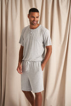 Men's bamboo pajama short set in grey matching shorts with drawstring and side pockets. Top is a t-shirt style with 3 buttons
