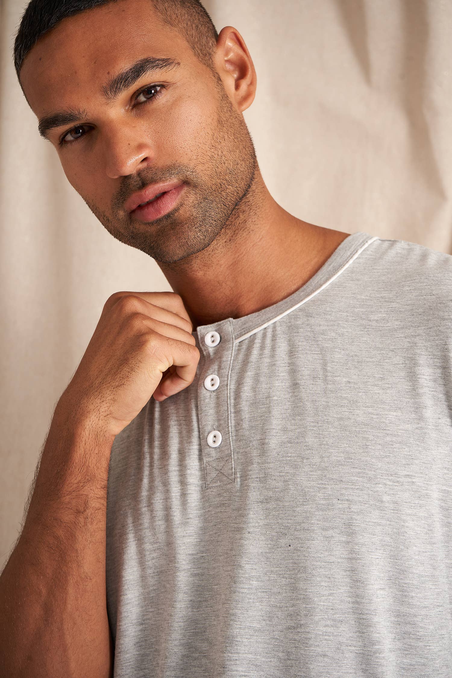Men's bamboo pajama short set in grey matching shorts with drawstring and side pockets. Top is a t-shirt style with 3 buttons