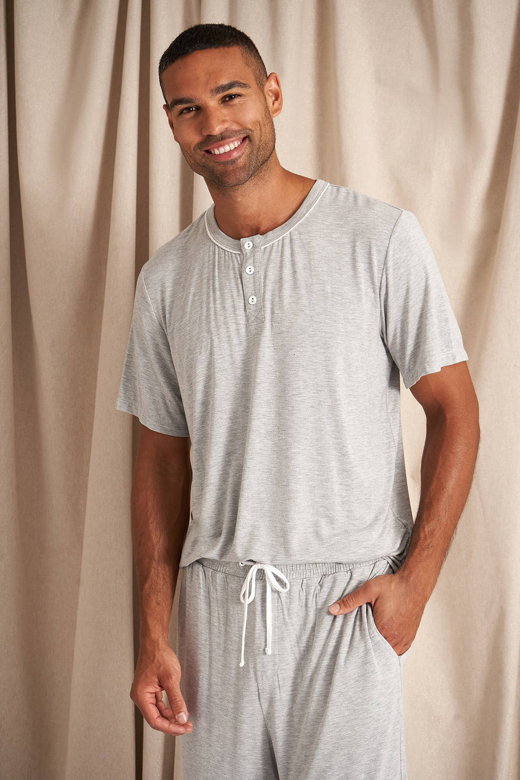 Men's bamboo pajama short set in grey matching shorts with drawstring and side pockets. Top is a t-shirt style with 3 buttons