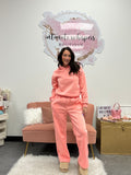 Pink sweat set with bow detail on back. Wide leg pants and hoodie sweatshirt