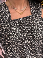 Women's black flowy floral tank top details