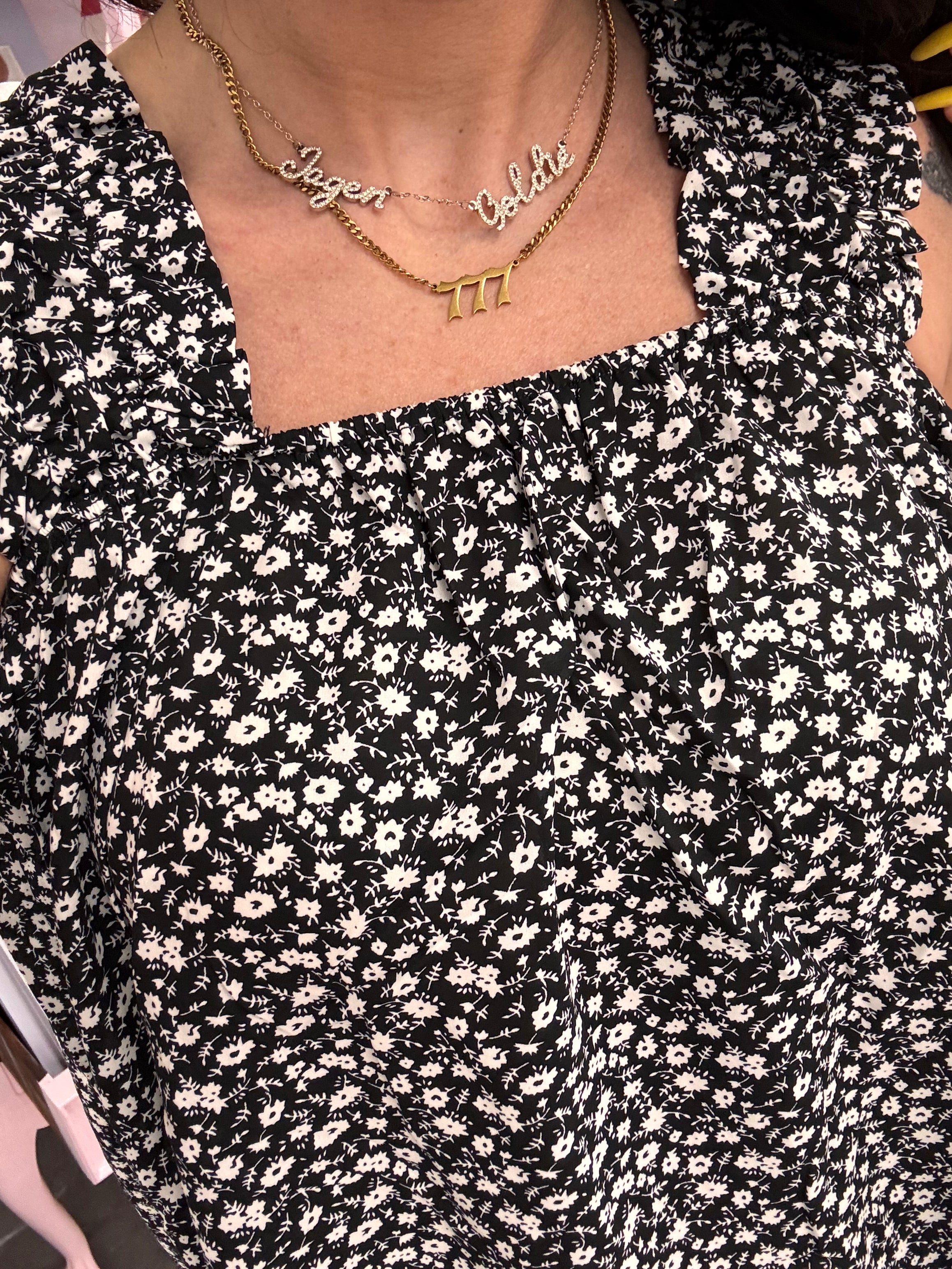 Women's black flowy floral tank top details