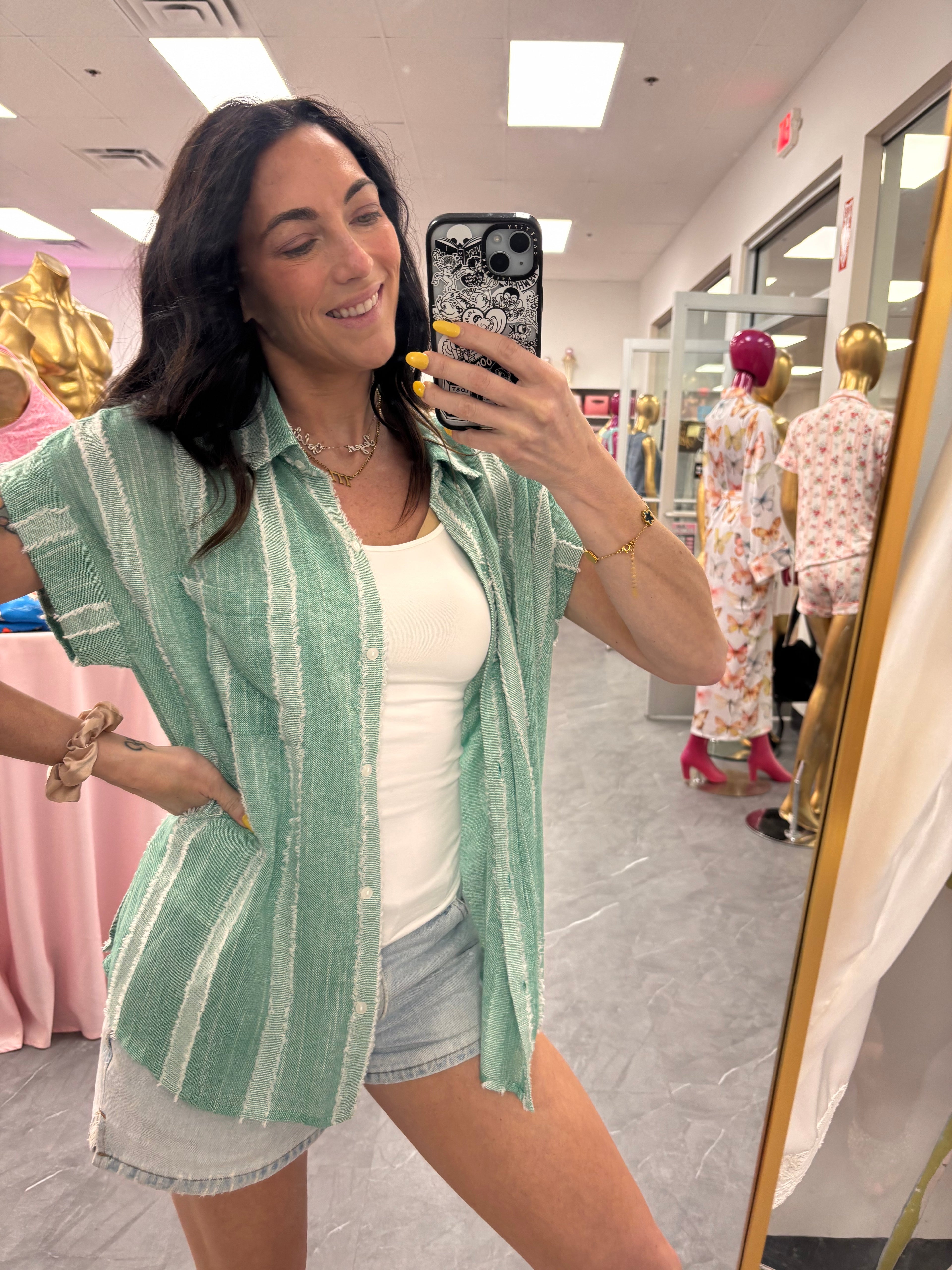 Women's frayed striped button up in mint worn open on model
