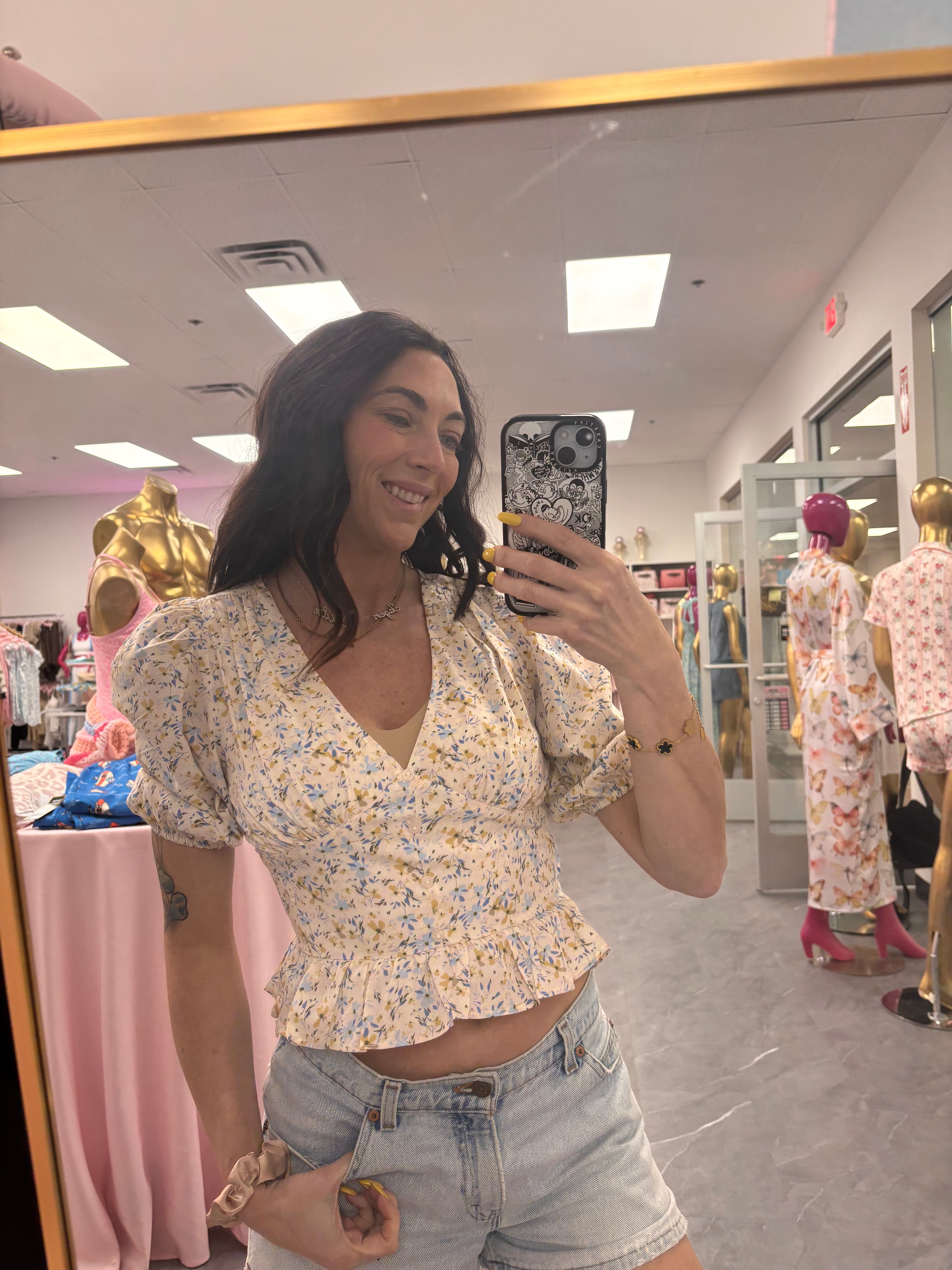 Women's floral ruffle vneck top with puffy sleeves on model close up