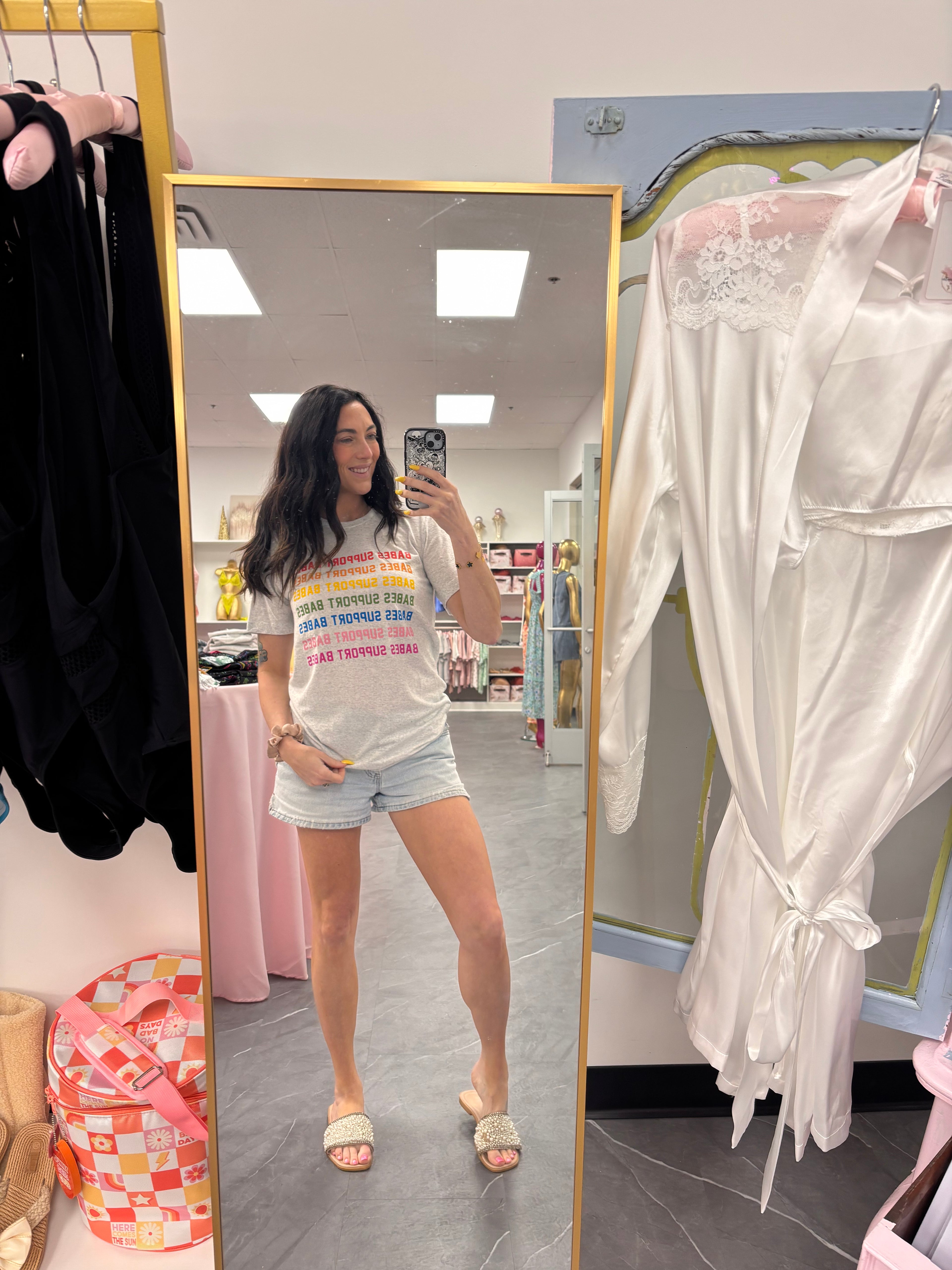 Women's grey t-shirt with "babes support babes" in rainbow font model full photo