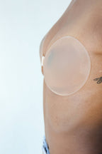 Womens adhesive reusable sticky bra nude with front clasp on model side view