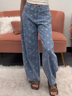 Women's denim barrel jeans with white cherry pattern on model