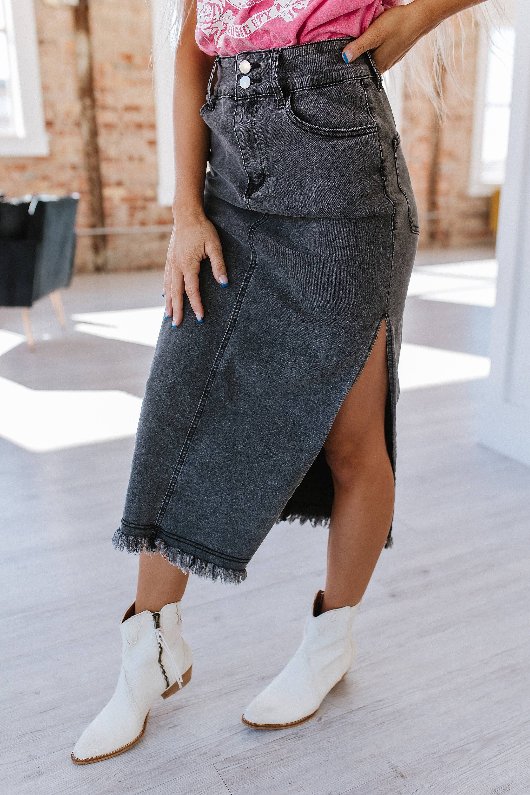 Women's black denim pencil midi skirt with slit on side with pockets zip and button. frayed hem