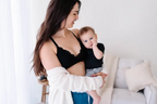 A black lace nursing bralette with adjustable racerback and drop-down cups, featuring a hook and eye clasp.