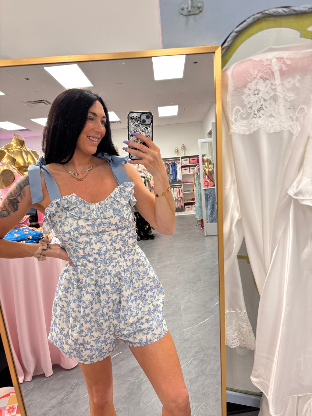 Women's blue floral romper with bow tie straps on model