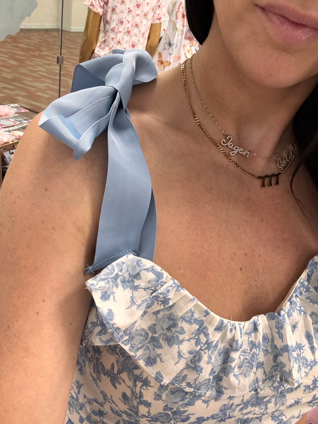 Women's blue floral romper with bow tie straps on model