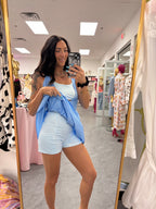 Women's blue gingham athletic dress with shorts underneath and pockets on model front