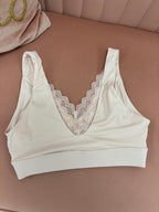 Women's blush pink pull over seamless bralette with lace back flat lay