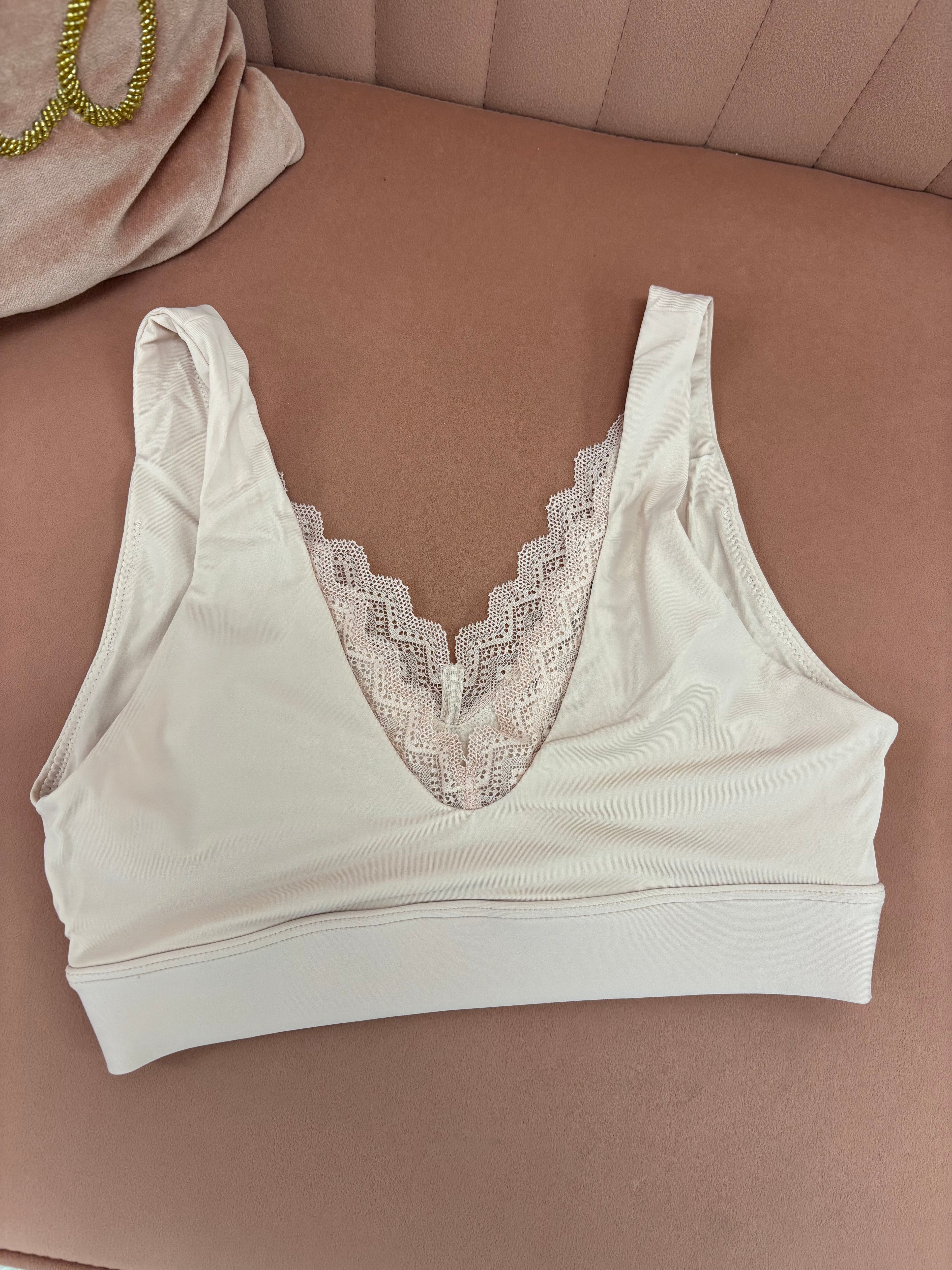 Women's blush pink pull over seamless bralette with lace back flat lay