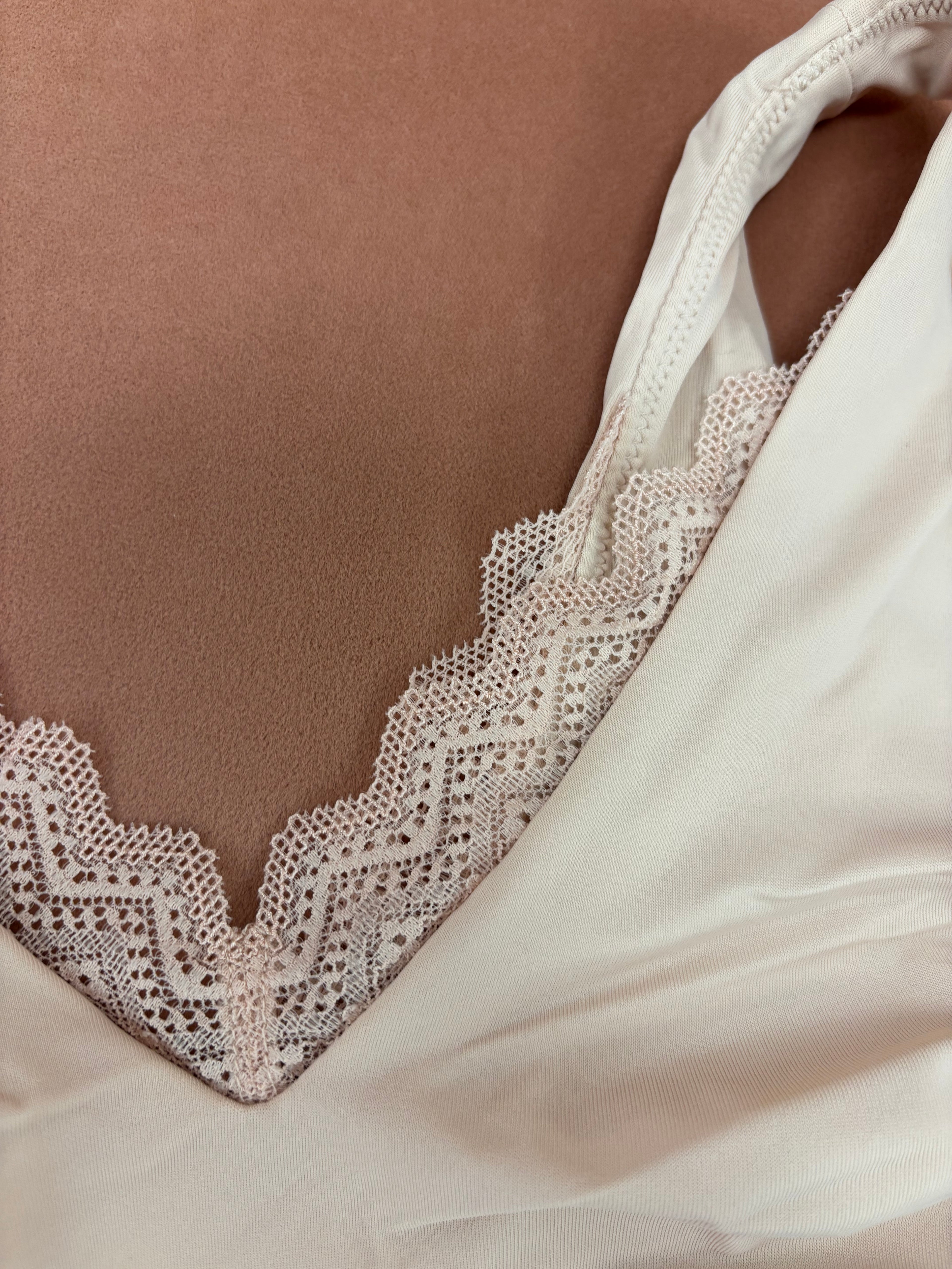 Women's blush pink pull over seamless bralette with lace close up detail