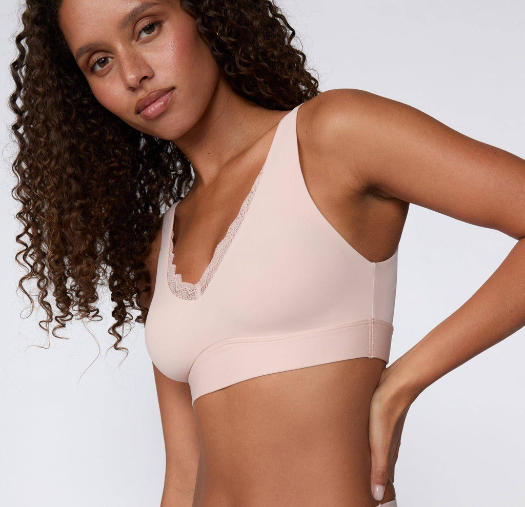Women's blush pink pull over seamless bralette with lace side detail