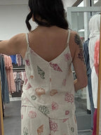 Women's cream tank top with seashells in different shapes and colors. Adjustable strap and v neck line