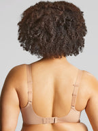 A woman wearing panache elegance beige, moulded cup bra with adjustable straps.