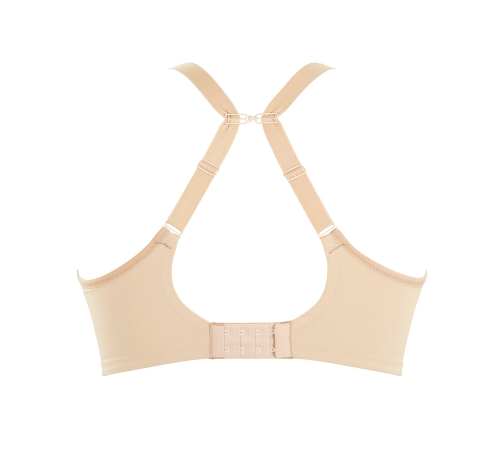 A woman wearing panache elegance beige, moulded cup bra with adjustable straps.