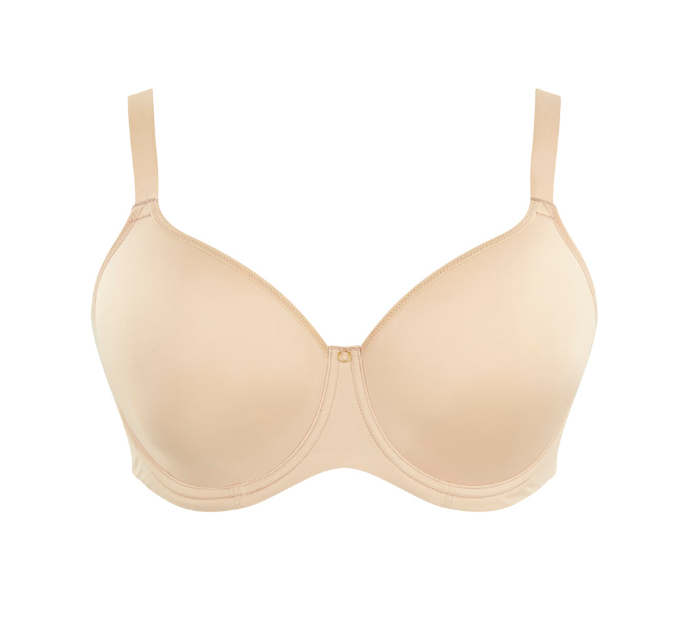 A woman wearing panache elegance beige, moulded cup bra with adjustable straps.