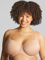 A woman wearing panache elegance beige, moulded cup bra with adjustable straps.