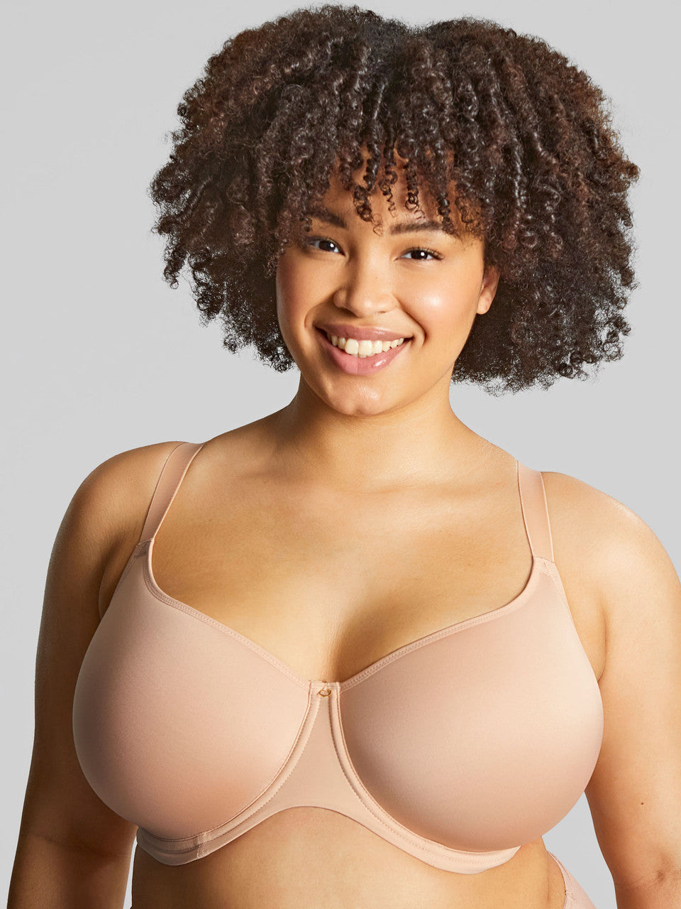 A woman wearing panache elegance beige, moulded cup bra with adjustable straps.