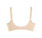 A woman wearing panache elegance beige, moulded cup bra with adjustable straps.