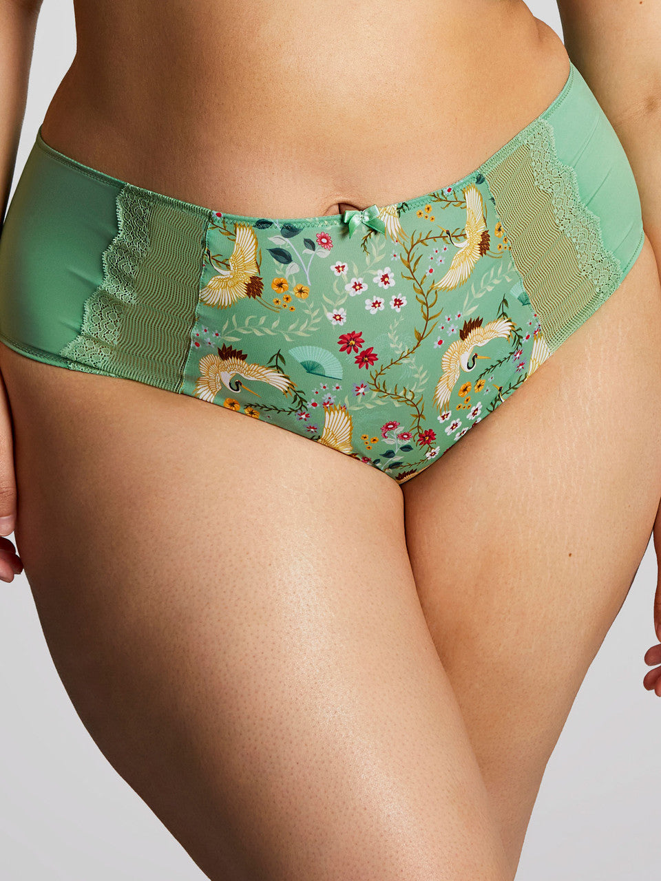 This image features the "Esme - Wonderland" deep brief, which is designed with a charming and whimsical aesthetic. The briefs are presented in a light mint green color, adorned with a playful pattern of animals and floral elements.