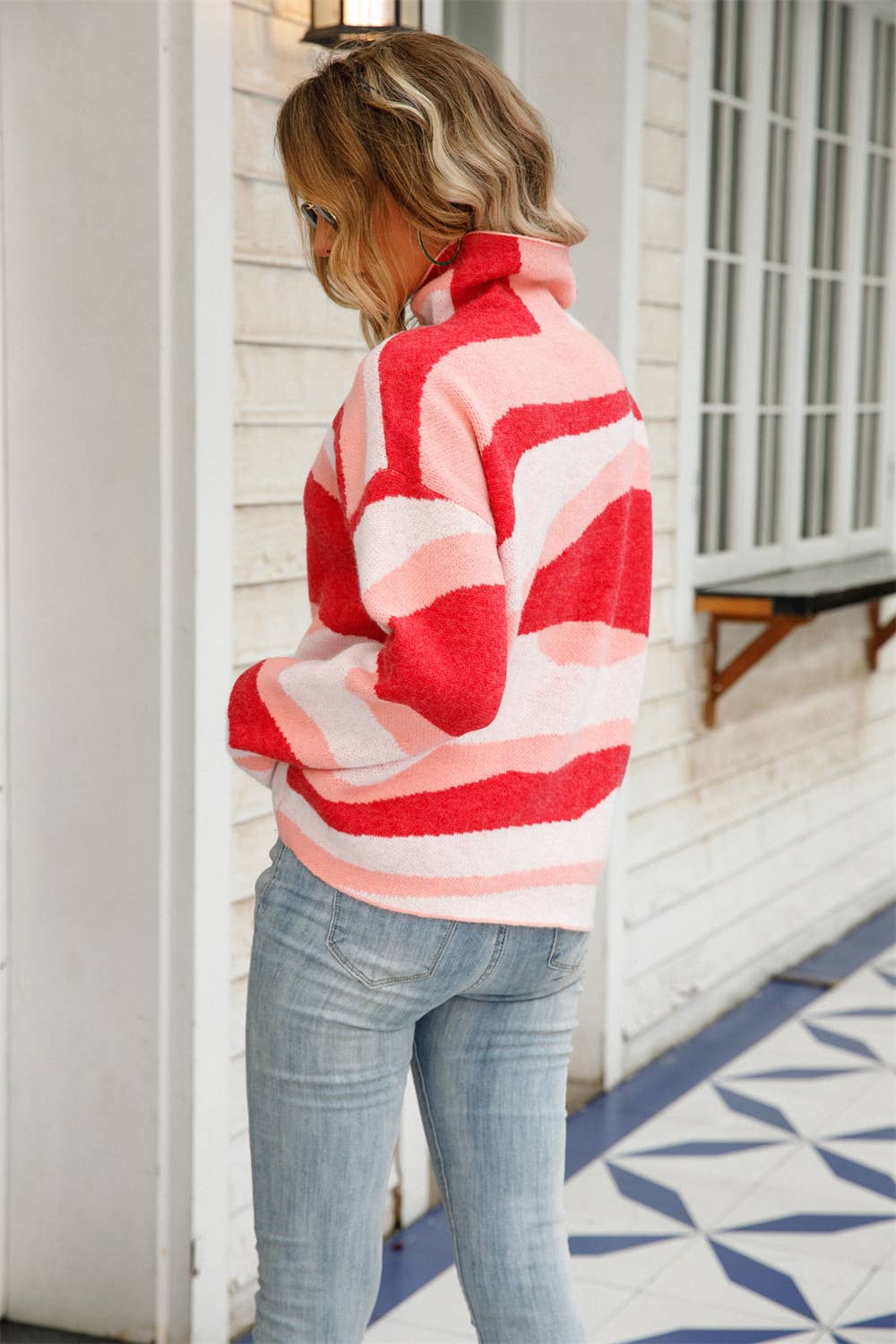 Women's tones of pink and white abstract pattern sweater with turtleneck on model