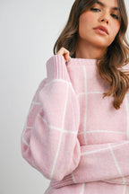 Women's pink checkered knit sweater on model front details