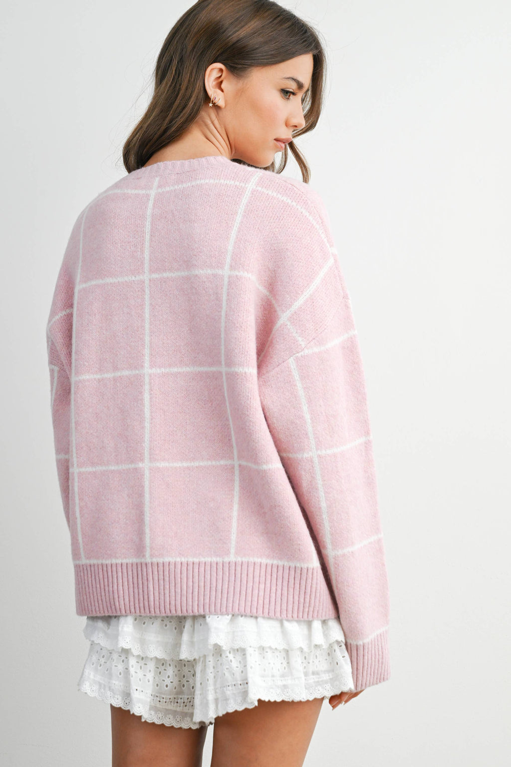 Women's pink checkered knit sweater on model back