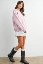 Women's pink checkered knit sweater on model front side