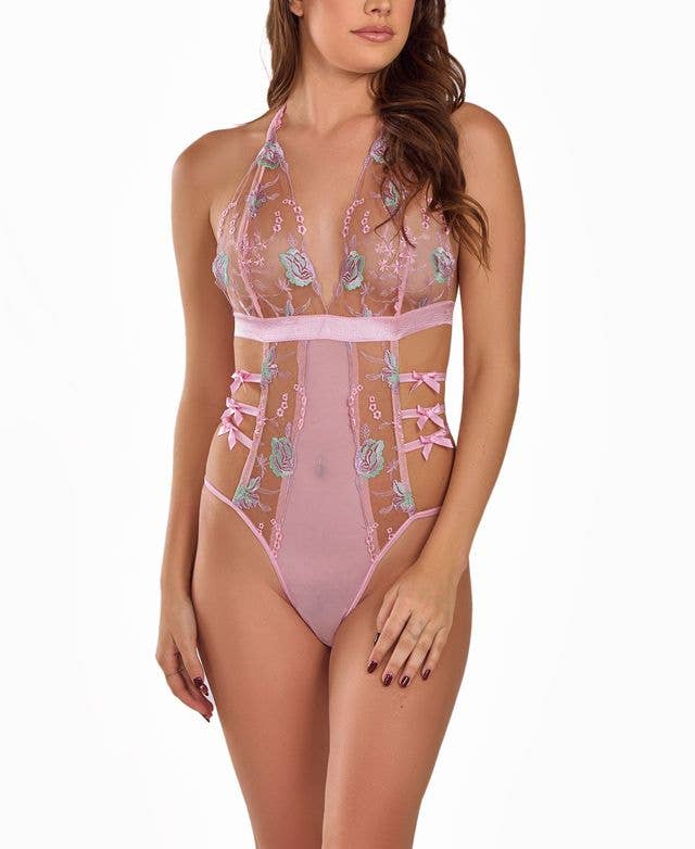 Women's pink floral embroidered lingerie bodysuit with side bows on model