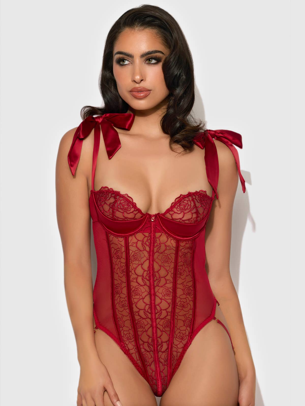 Women's red lace bodysuit lingerie with ribbon tie straps on model