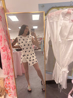 Women's 2 piece skort set white and black polka dot athletic leisure outfit on model full outfit