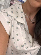 Women's white quarter zip sleeveless floral two piece set front close up zip detail
