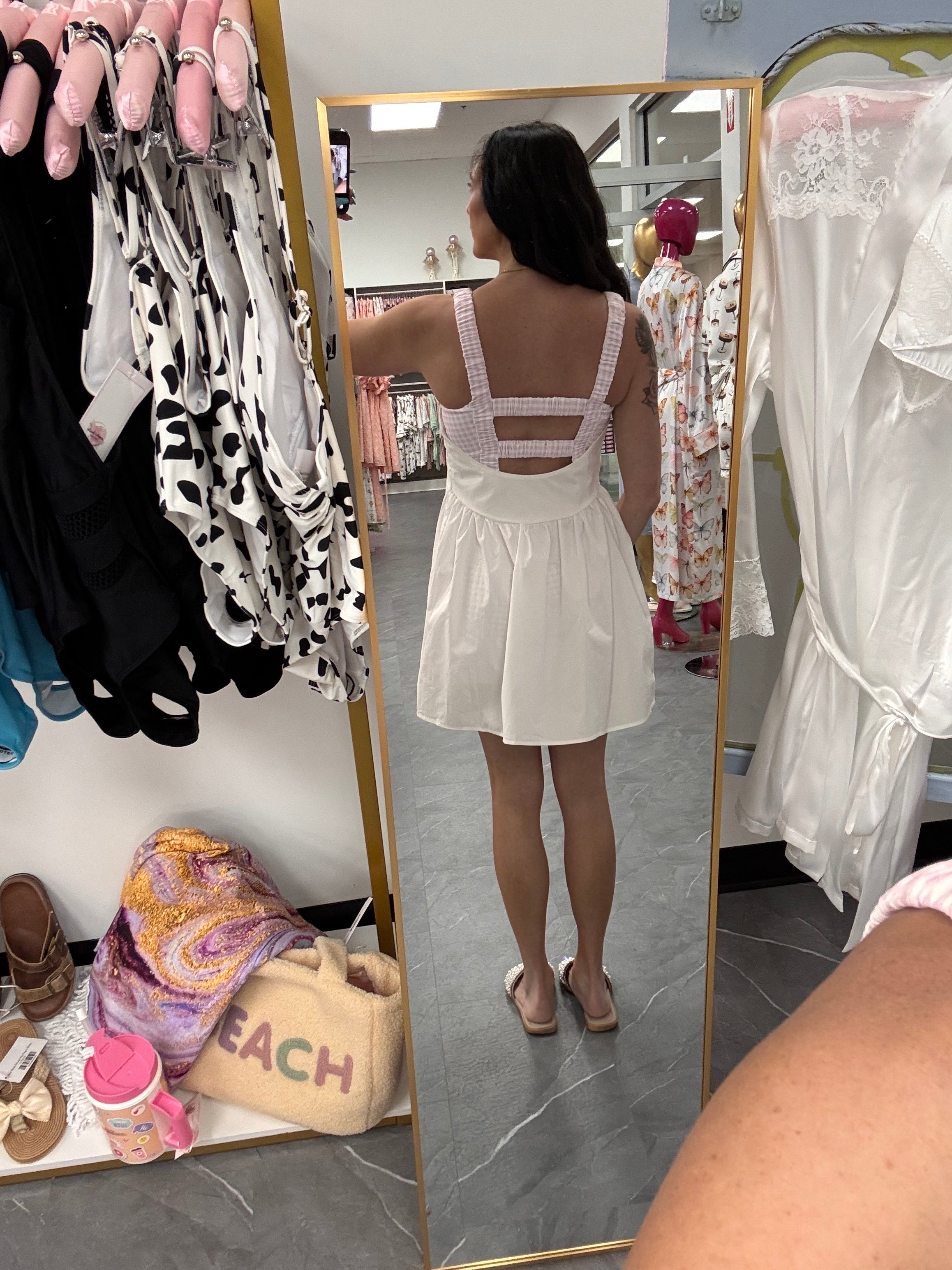 Womens white and pink gingham athletic dress with romper shorts underneath on model
