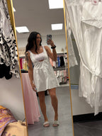 Womens white and pink gingham athletic dress with romper shorts underneath on model