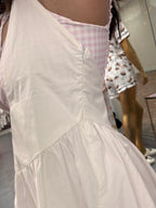 Womens white and pink gingham athletic dress with romper shorts underneath on model zipper detail