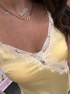 Women's yellow satin camisole tank top with white lace
