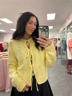 Women's yellow three tie up the front cardigan with crochet like details.