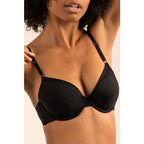 A woman wearing a black demi-coverage bra with soft mesh details and memory foam cups.